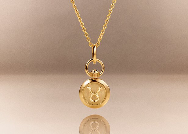 Gold tone taurus zodiac charm necklace