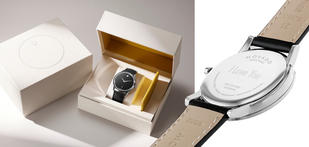 White Movado packaging closed with the movado logo on top, next to the box open with a Museum Classic watch with black leather strap and black dial sitting inside of it. An image of the back of a watch with "I Love You" engraved in the case back.