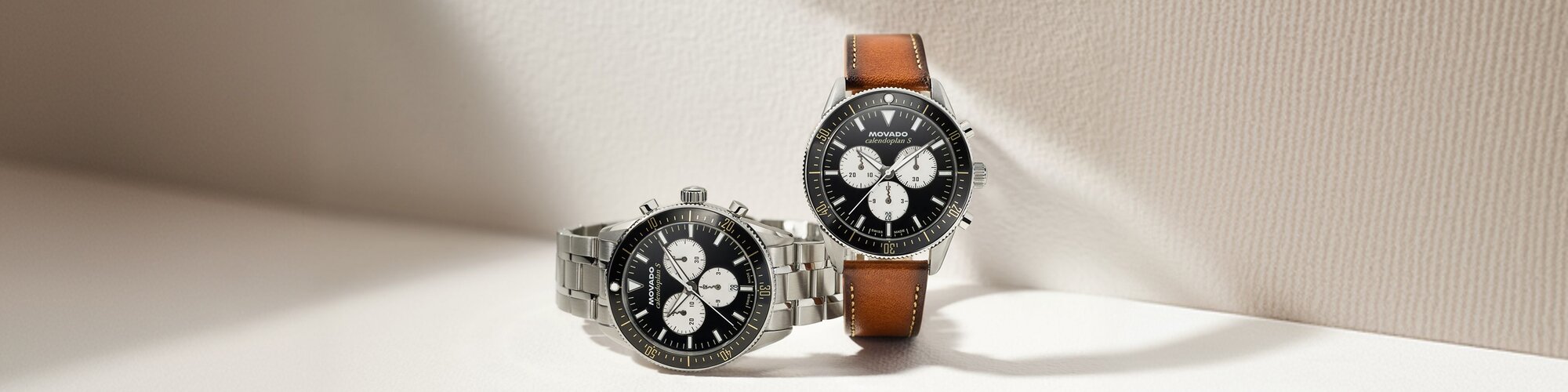 Two Heritage Series Calendoplan S watches one with stainless steel bracelet and black and white chronograph dial and the other with brown leather strap with black and white chronograph dial.