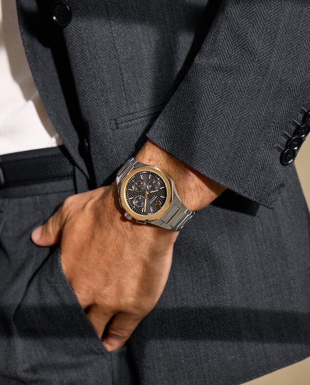 Man in a suit wearing the Two Tone Alta Centurion Chronograph bracelet watch with 18K Gold Bezel.