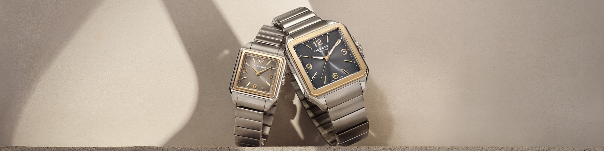 Men's and Women's Two tone Heritage 2927 bracelet watches leaning on one another.