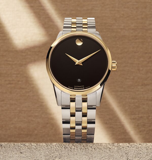 Museum classic watch with two tone bracelet and black dial.