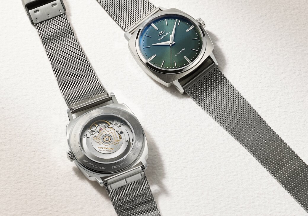 Heritage Kingmatic Automatic watch with stainless steel mesh bracelet and blue dial laying next to the back of the watch showcasing the exposed caseback.