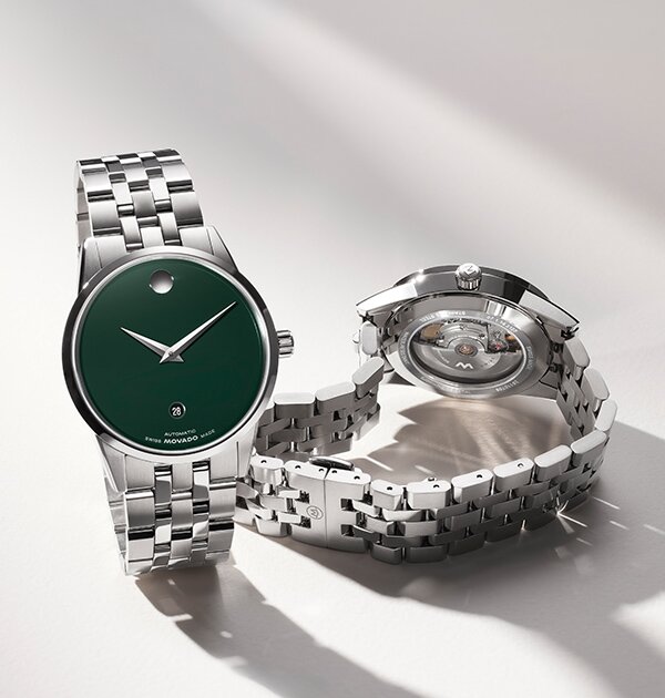 Front a silver watch with green dial and the back of the silver watch with an exposed automatic movement