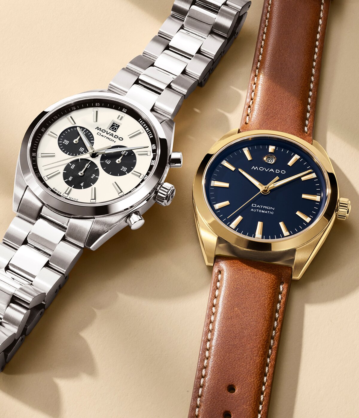 Heritage Series Datron watch with stainless steel bracelet and chronograph dial laying next to another Heritage Series Datron watch with brown strap and blue dial.