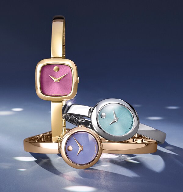 Museum Bangle watches in gold tone with pink dial, rose gold tone with purple dial and silver with blue dial.
