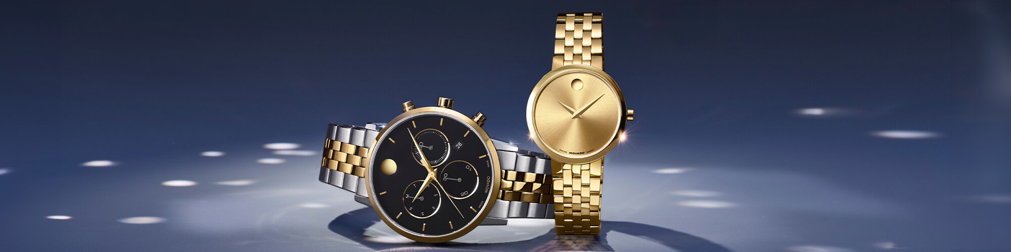 Two tone Museum Classic chronograph watch with black dial next to a gold tone women's Museum Classic watch.