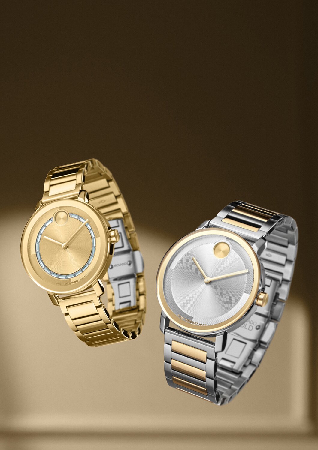 Women's BOLD Evolution 2.0 gold tone watch with crystals floating next to a Men's two toned BOLD Evolution 2.0 watch.