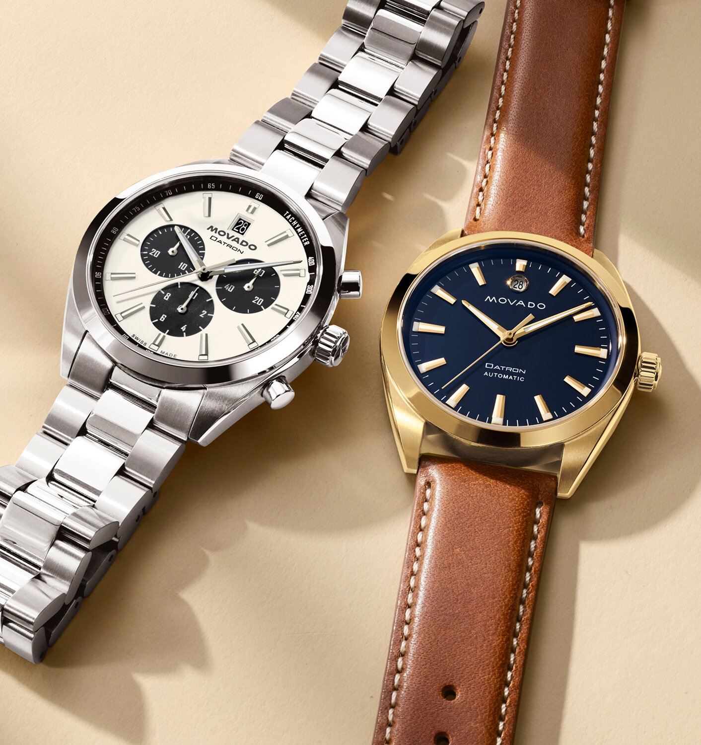 Heritage Series Datron watch with stainless steel bracelet and chronograph dial laying next to another Heritage Series Datron watch with brown strap and blue dial.