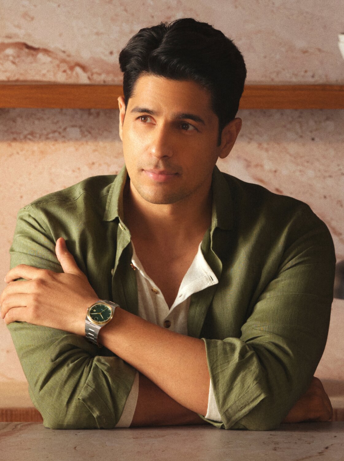 Sidharth Malhotra in a green button down wearing the BOLD Quest Automatic with stainless steel bracelet and green dial.