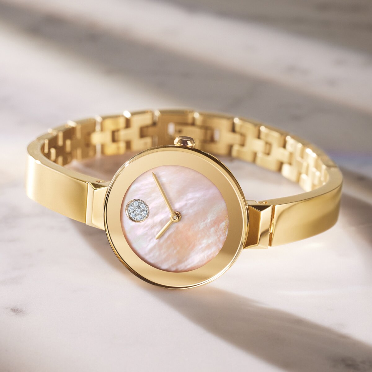 Gold tone BOLD Bangle watch with mother of pearl diamond and crystal dot