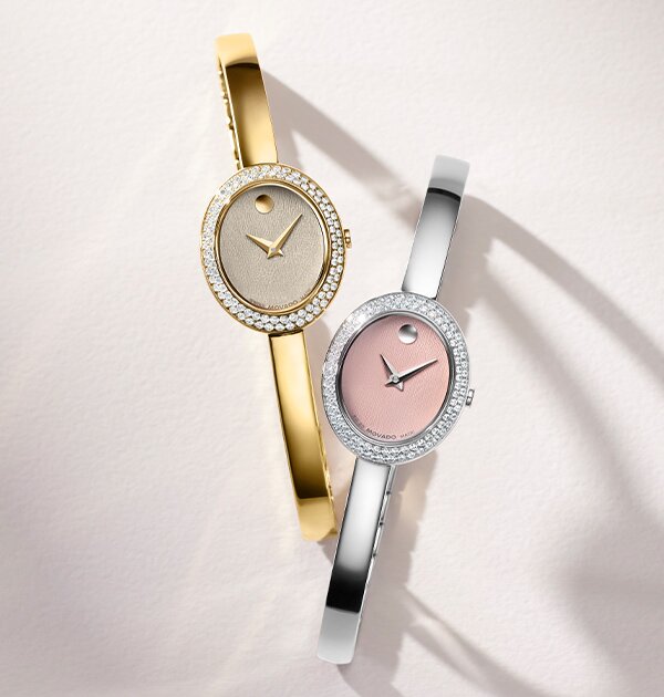 Gold tone Museum Bangle watch with lab grown diamond bezel next to silver bangle watch with pink dial and lab grown diamond bezel.