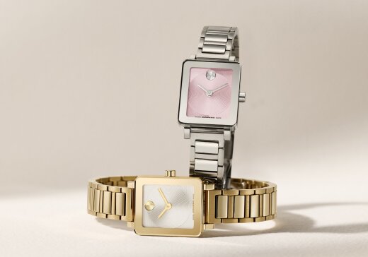 BOLD Evolution 2.0 Mini watch with stainless steel bracelet and square pink dial behind a gold tone BOLD Evolution 2.0 Mini watch laying on its side.