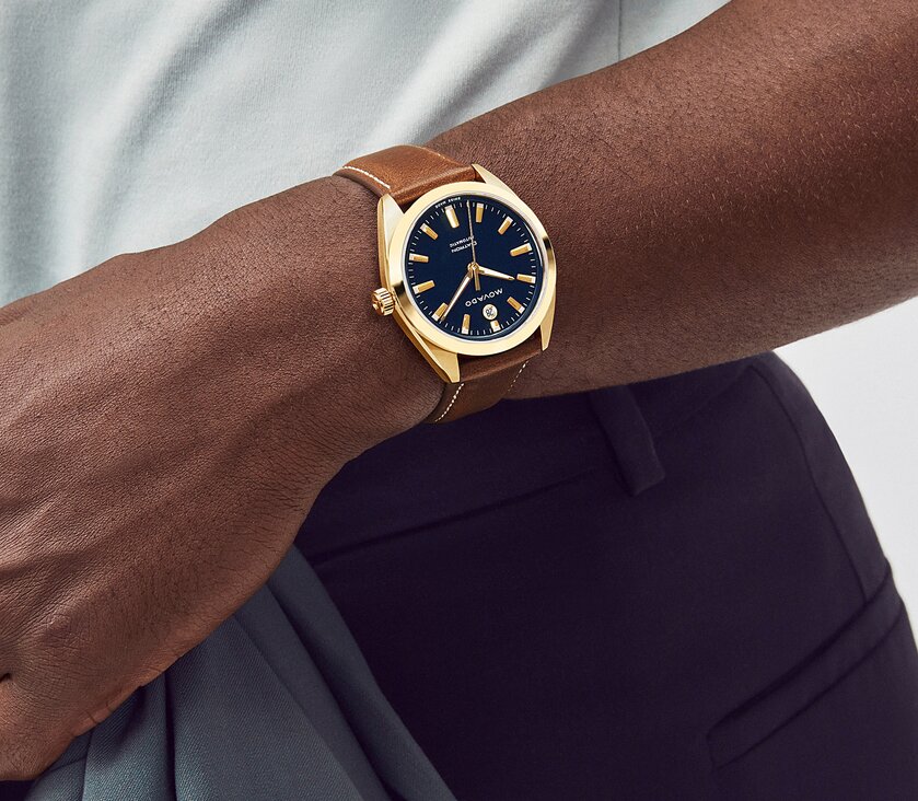 Man wearing the Heritage Datron watch with brown leather strap and blue dial.