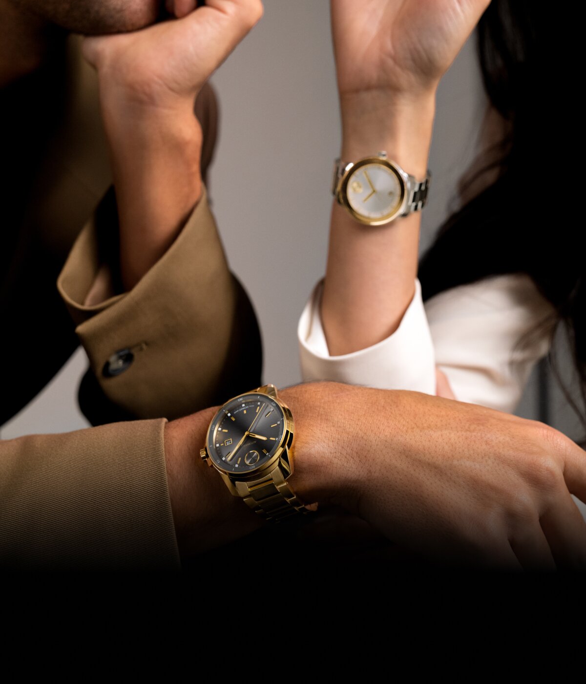 Movado BOLD Verso watch with gold bracelet and grey dial worn on a man and a Movado BOLD Verso two toned watch worn on a woman.