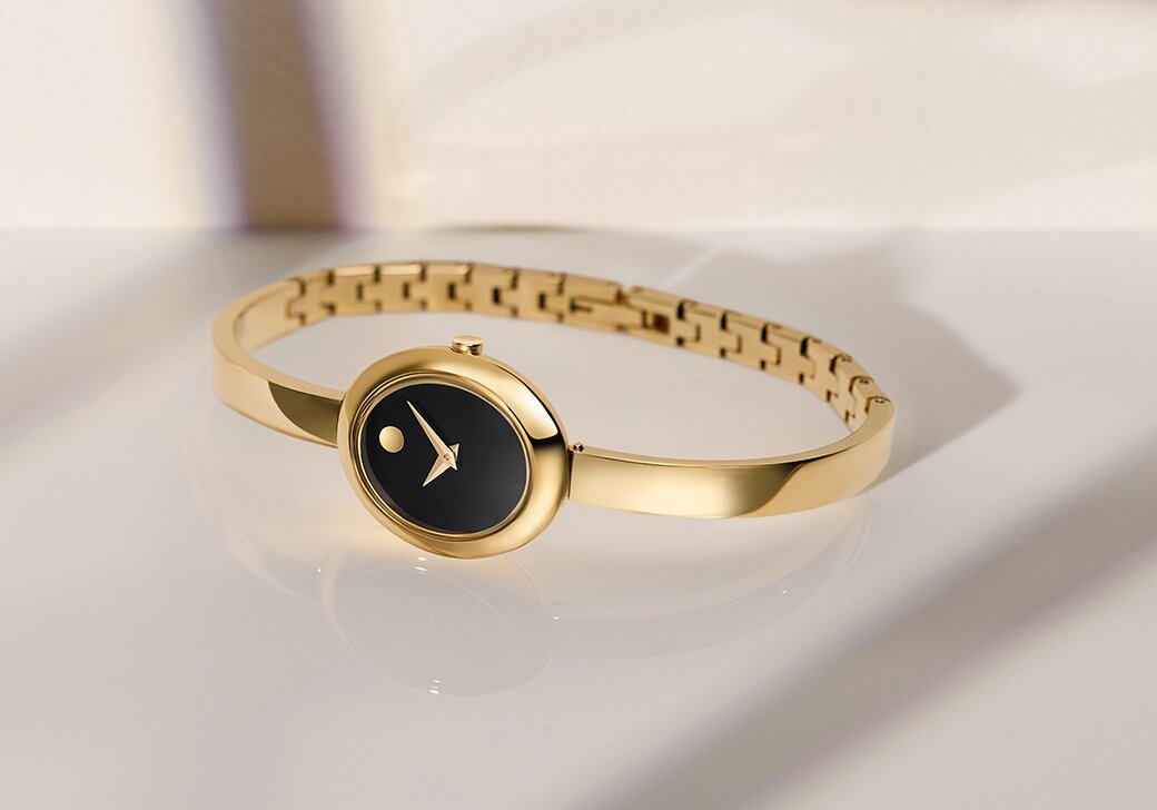 Gold tone Museum Bangle with black oval dial.