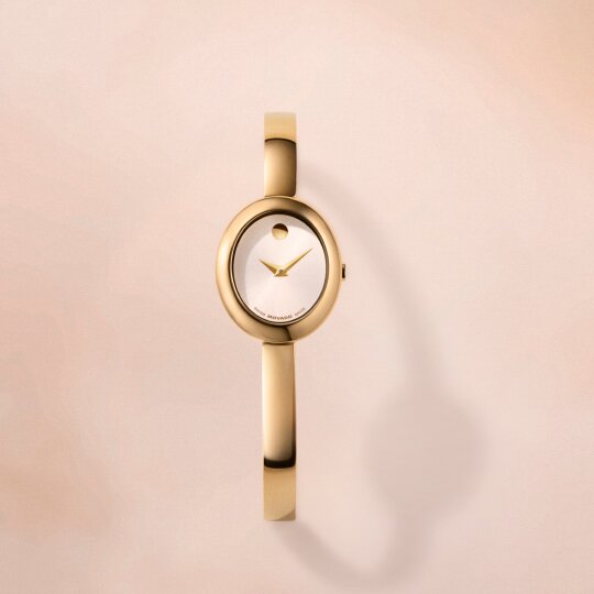 Gold tone Museum Bangle watch with white oval dial.