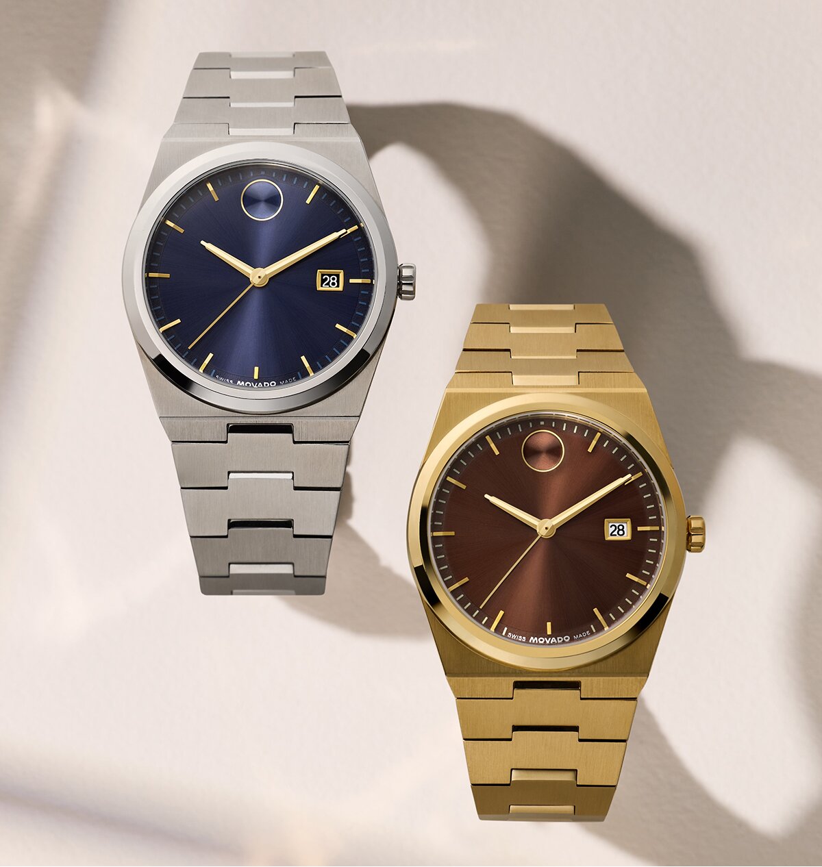 BOLD Quest watch with stainless steel bracelet and blue dial next to another BOLD Quest watch with gold tone bracelet and brown dial.