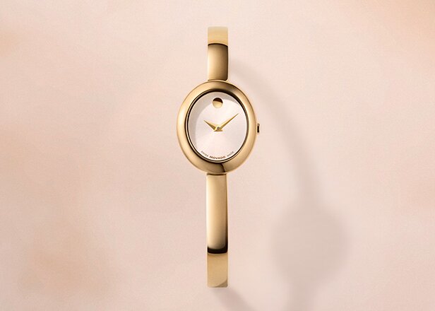 Gold tone Museum Bangle with white oval dial.