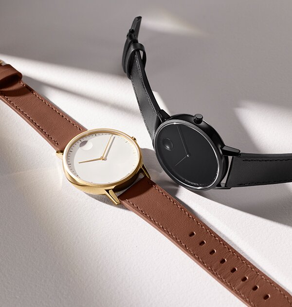 Face watch with brown strap and white dial next to a black Face watch.