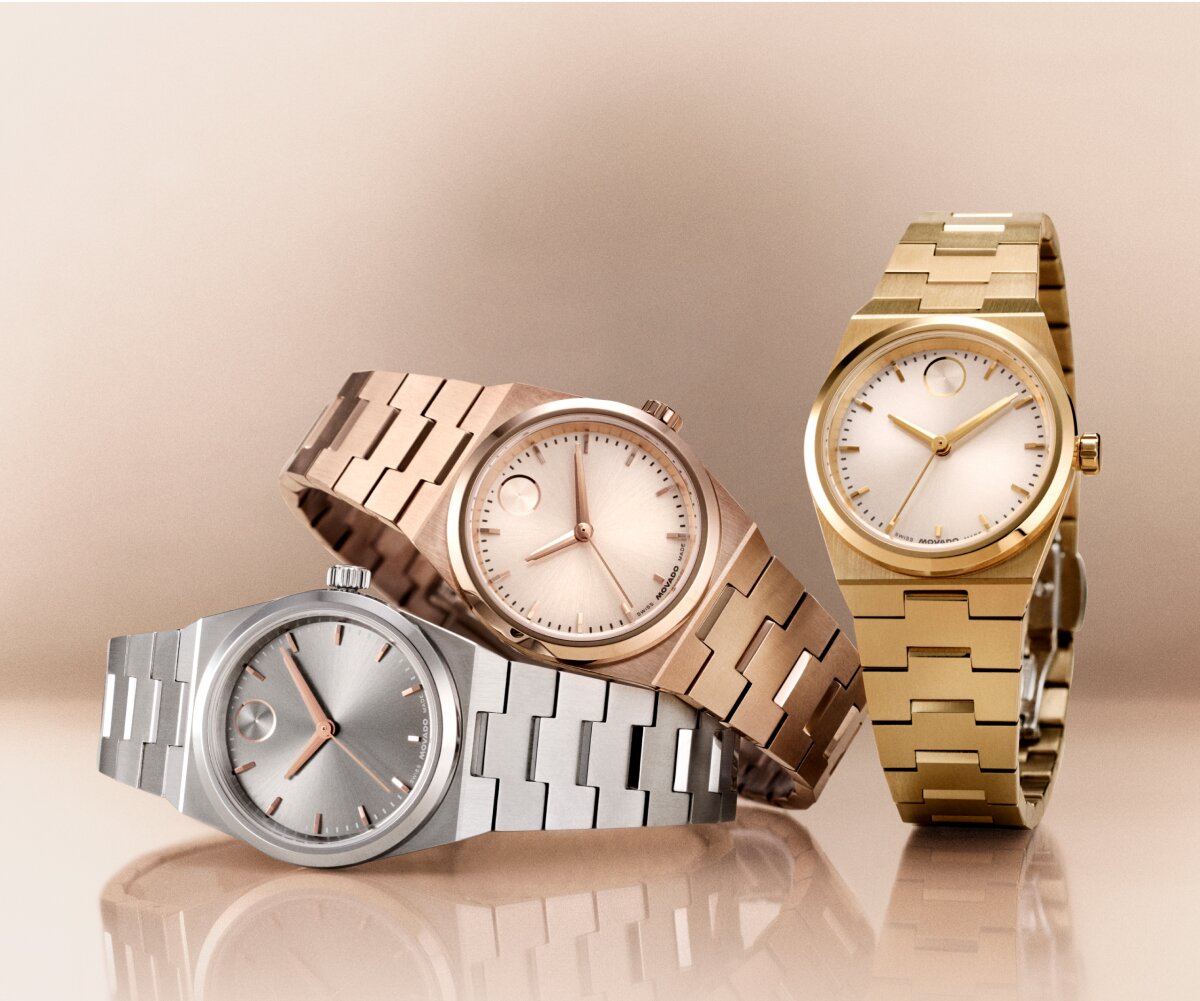 Rose gold tone BOLD Quest Mini watch laying on top of a silver BOLD Quest Mini watch with a gold tone BOLD Quest mini watch to the right.