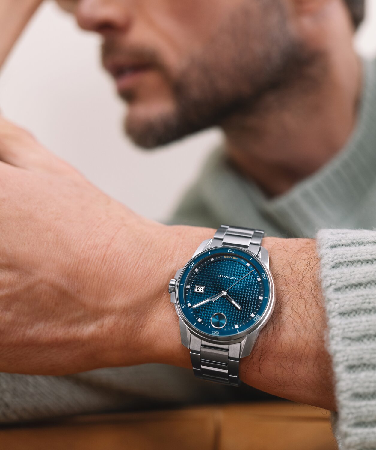 Man wearing a BOLD Verso Automatic  stainless steel bracelet watch with blue dial.