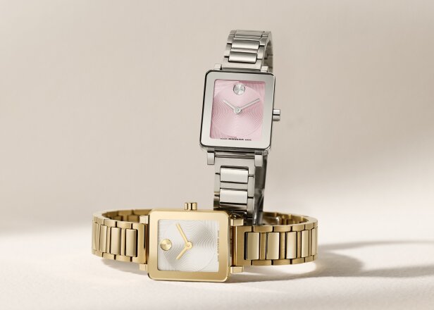 BOLD Evolution 2.0 Mini watch with stainless steel bracelet and square pink dial behind a gold tone BOLD Evolution 2.0 Mini watch laying on its side.