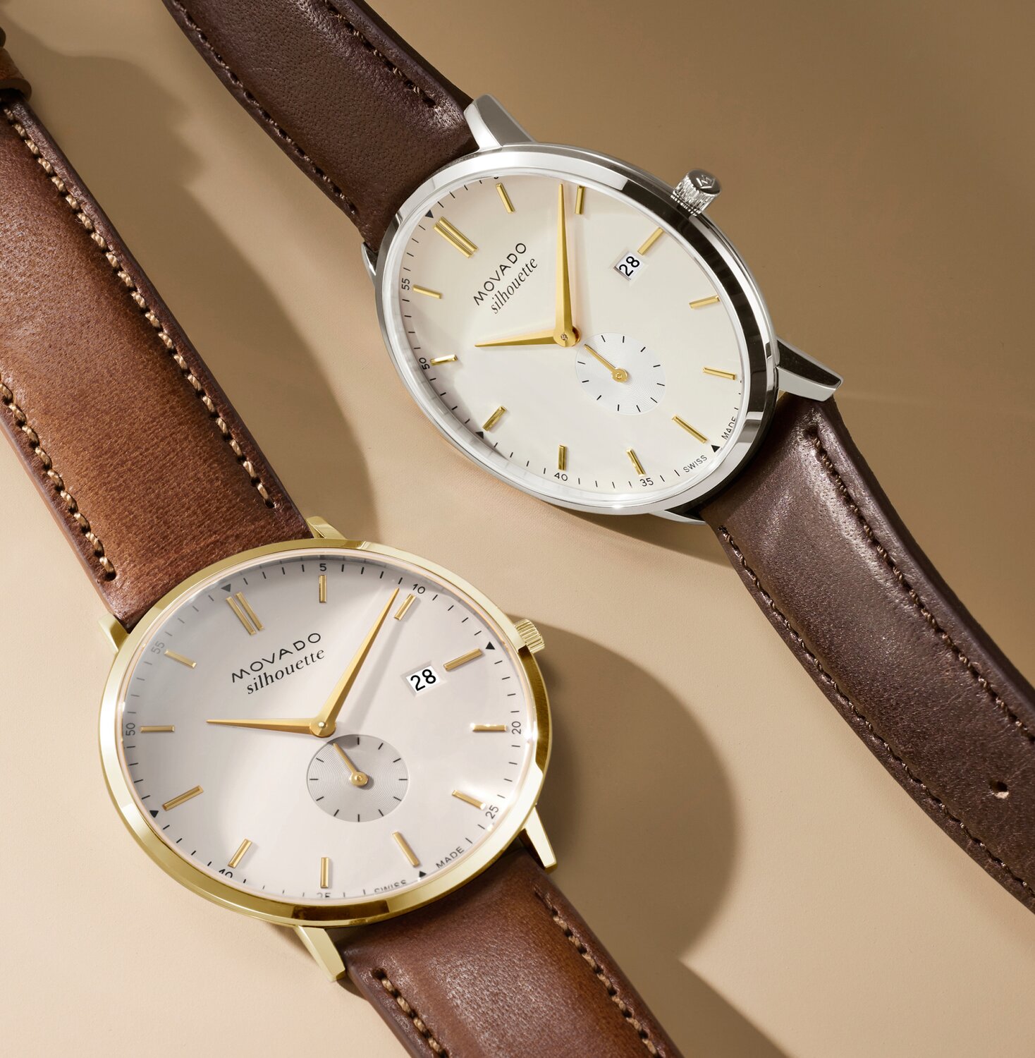 Heritage Silhouette watch with light brown leather strap and white dial next to the Heritage Silhouette watch with dark brown leather strap and white dial.