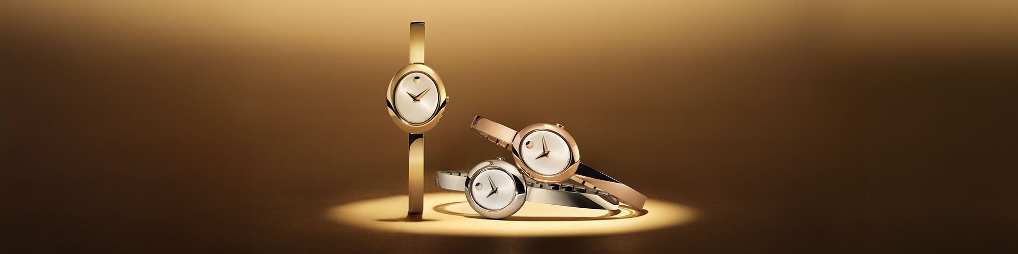 Three Museum Bangle watches with oval dial in gold tone, silver and rose gold tone.