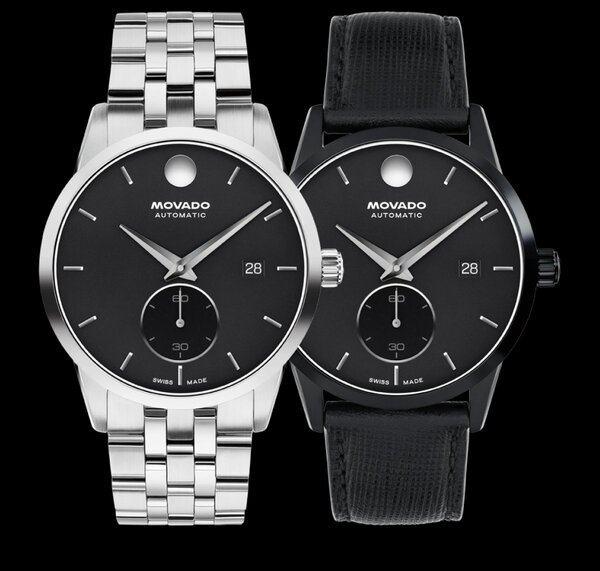 Museum Taga watch with stainless steel bracelet and black dial next to Museum Taga with black leather strap and dial.