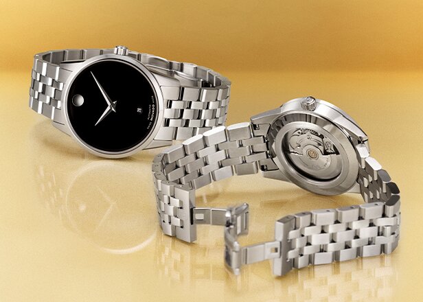 Museum Classic Automatic watch with silver bracelet and black dial next to the back of the watch with an exposed automatic movement case back