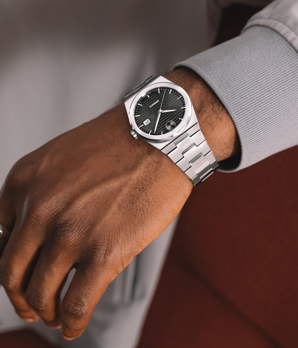 Man in a grey jacket wearing a Movado BOLD Quest Automatic on his wrist.