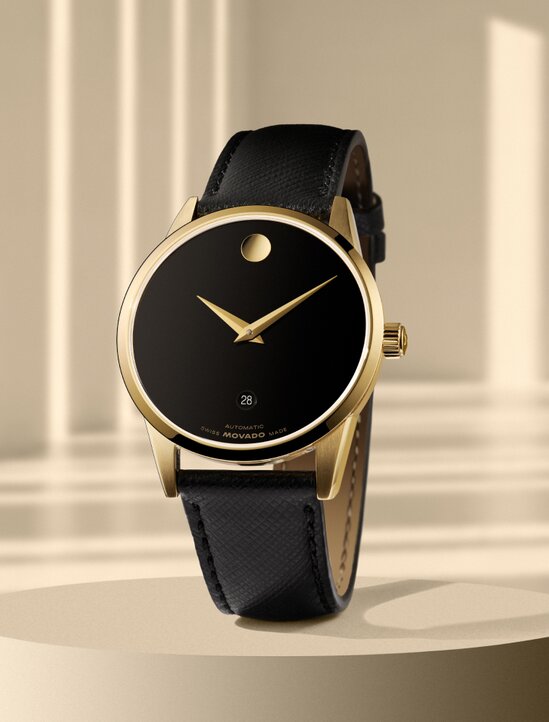 Black Museum Classic watch with leather strap and gold accents.