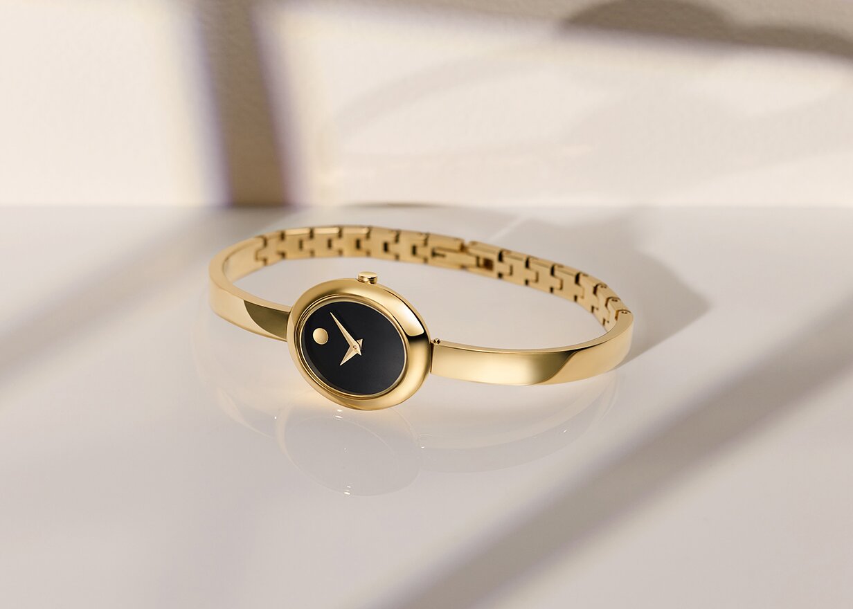 Gold tone Museum Bangle with black oval dial.