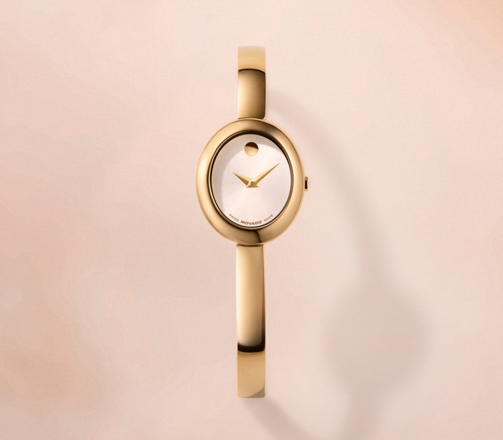 Gold tone Museum Bangle watch with white oval dial.