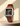 Heritage 1917 watch with brown strap and green square dial with stainless steel accents.