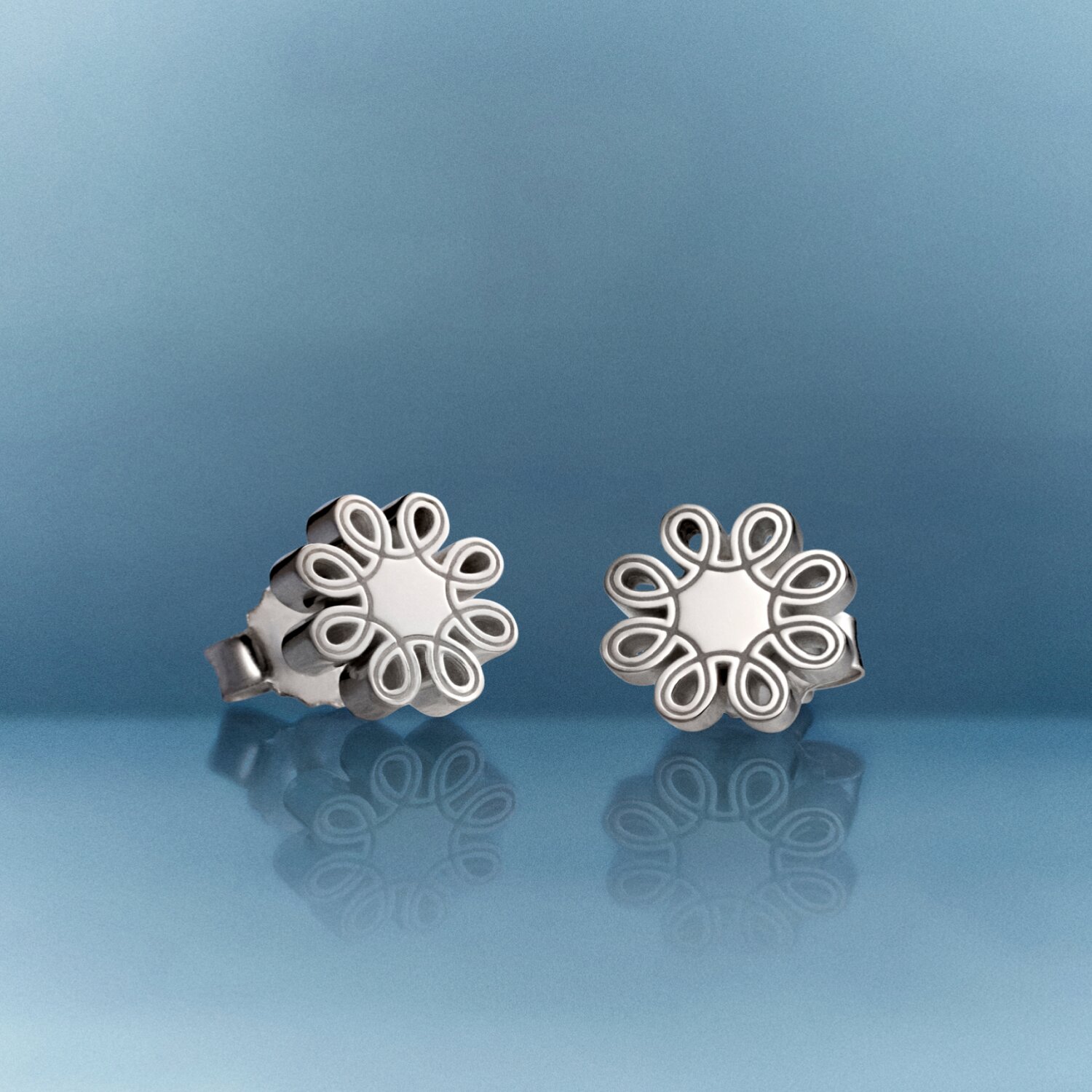 Silver women's fleur stud earrings.