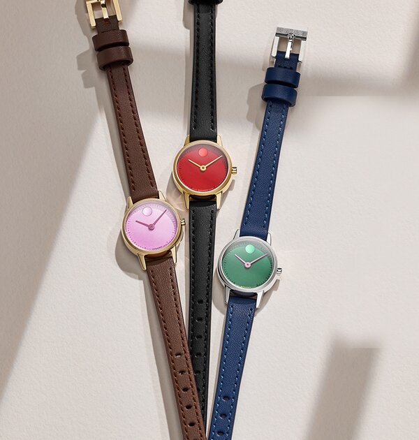 Baby Face watch with brown leather strap and purple dial, next to a Baby Face watch with black strap and red dial, next to a Baby Face watch with blue strap and green dial.
