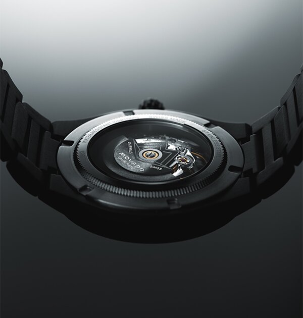 Back of a black PVD watch with exposed caseback that shows the automatic movement
