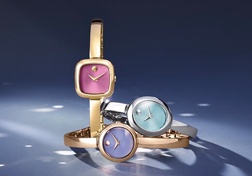 Museum Bangle watches in gold tone with pink dial, rose gold tone with purple dial and silver with blue dial.
