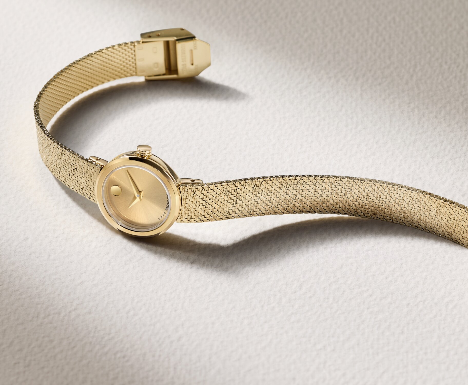Gold tone Museum Velura Mini watch with mesh bracelet.