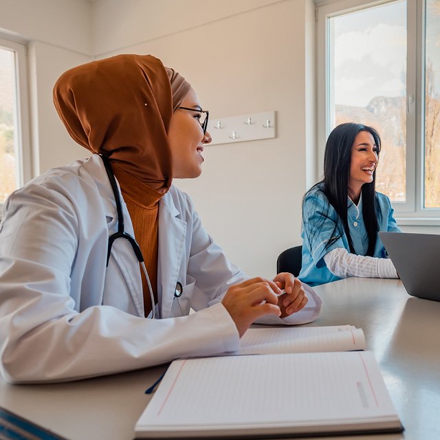 Healthcare Professionals smiling across the table