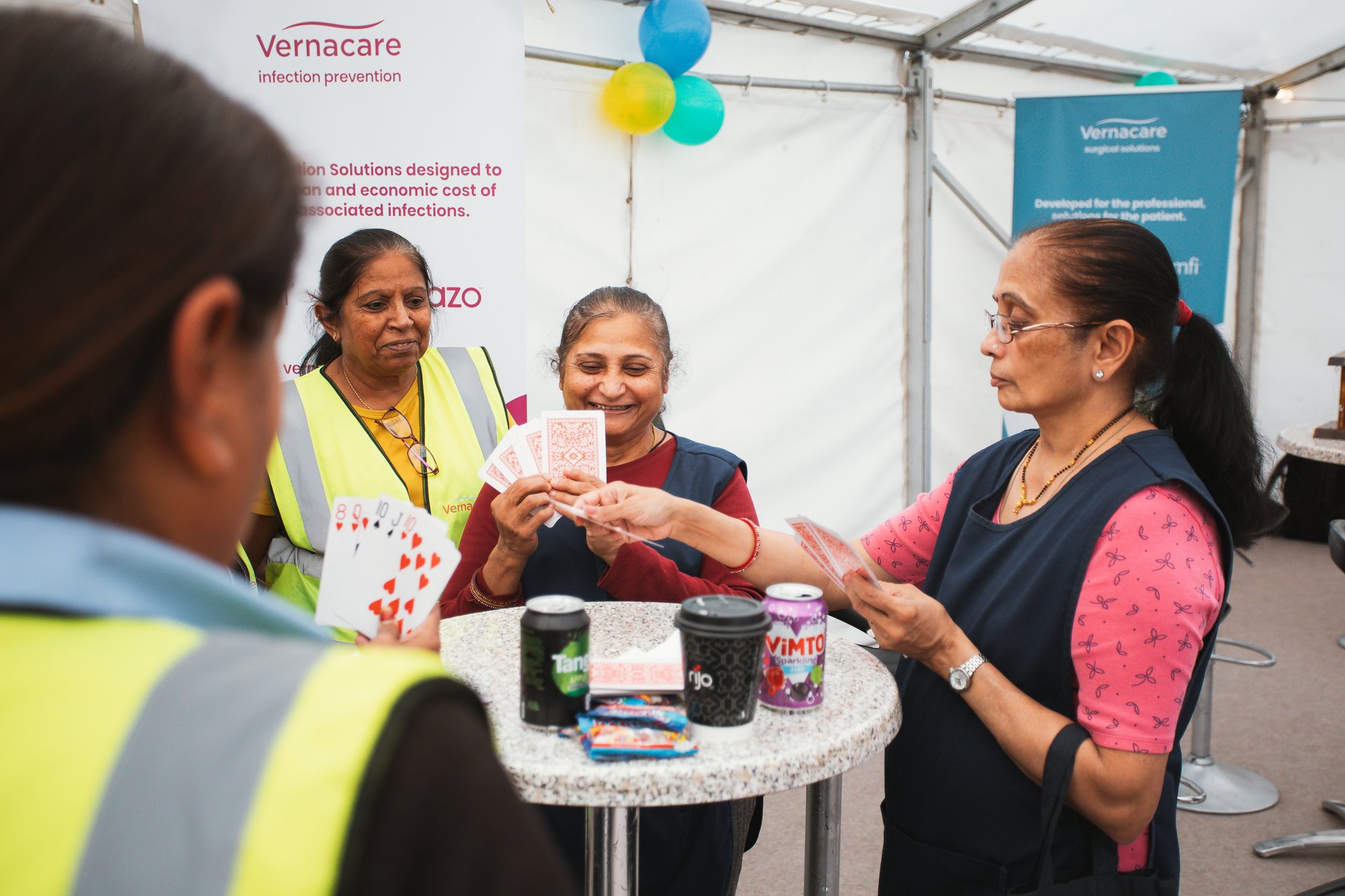 Employees playing a card game at a social event