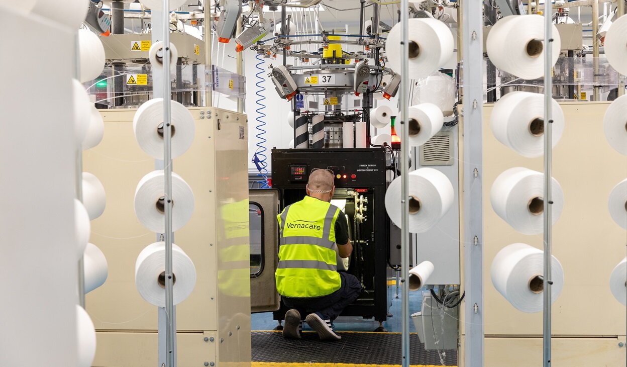 A production operative operating machinery in the Comfi bandage facility