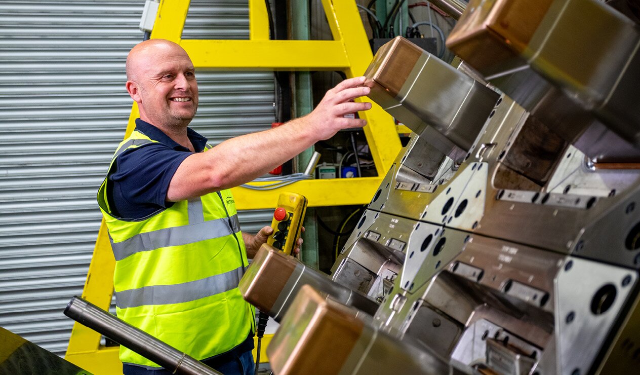 A toolroom operative viewing the injection moulding moulds