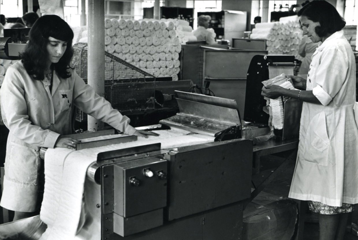 Two women producing wool on a machine in the 1940s