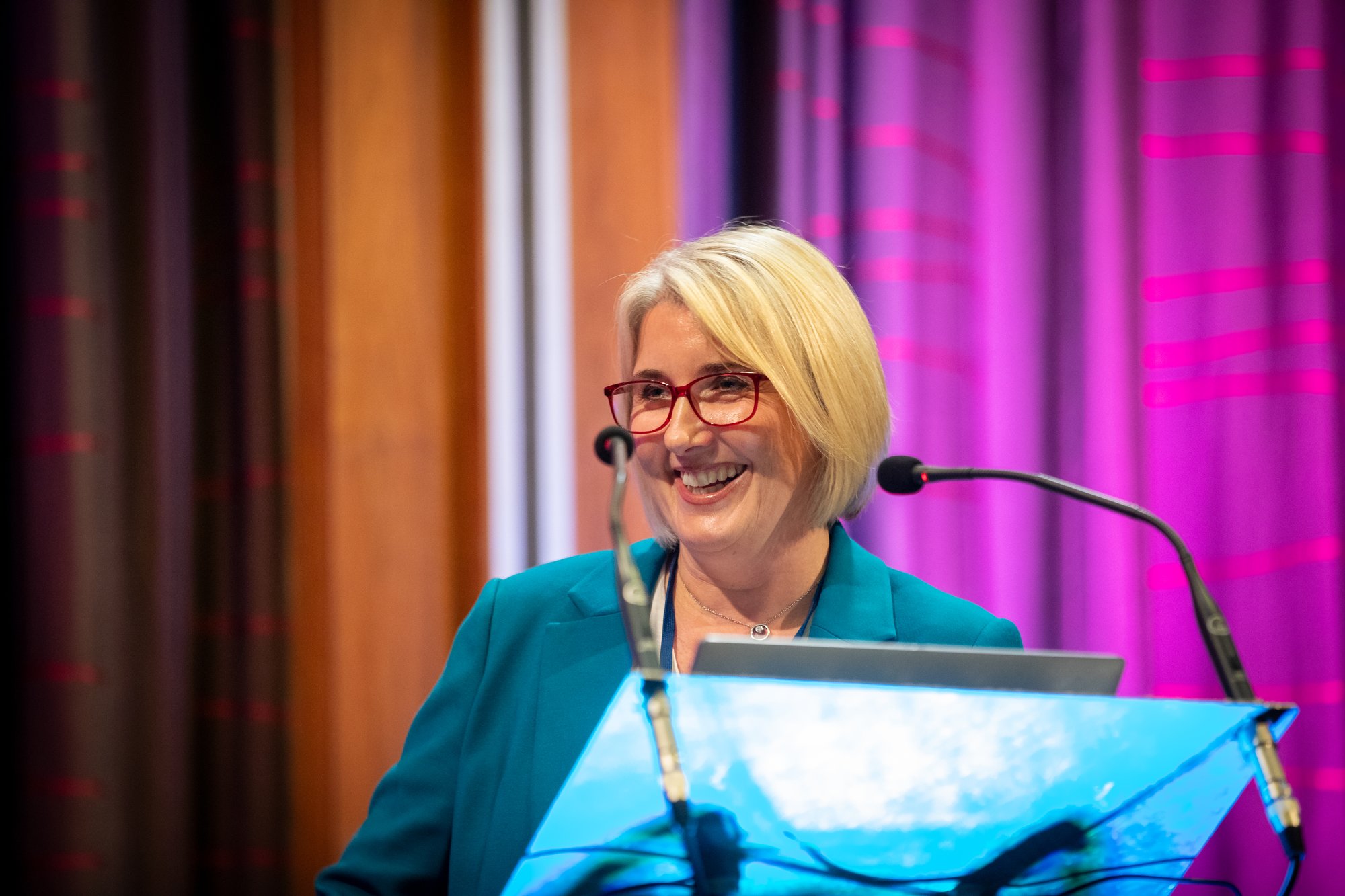 A businesswoman smiling at a conference