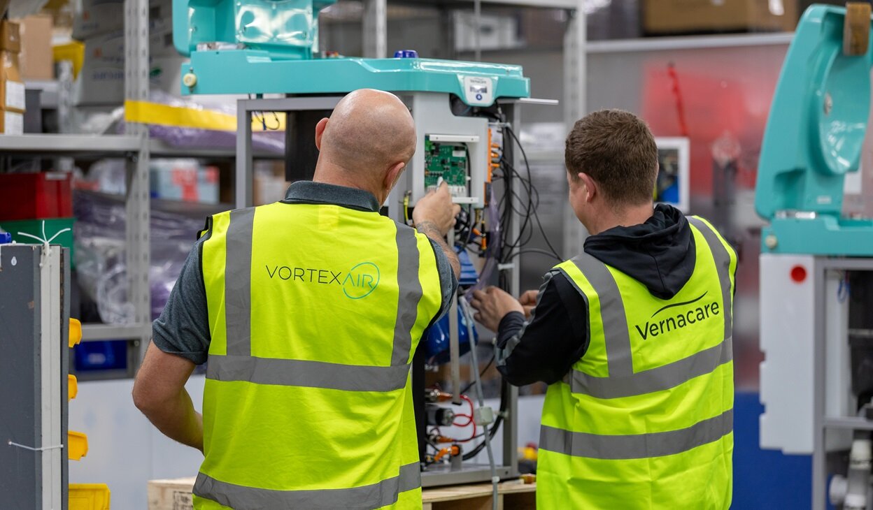 Two production operatives assembling a Vortex Air macerator