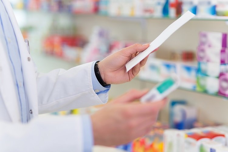 A pharmacist reading a prescription