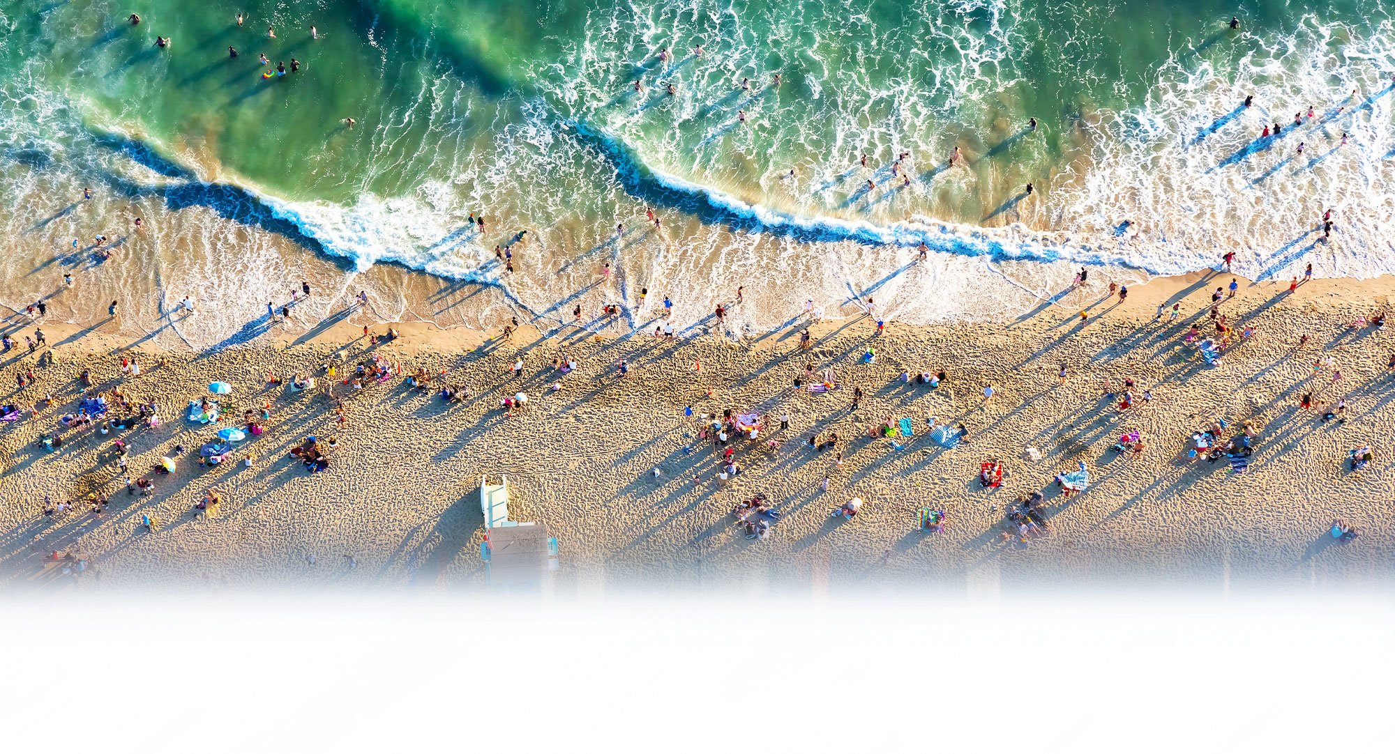 Cross Country Healthcare color aerial photo of people on a sandy beach.                